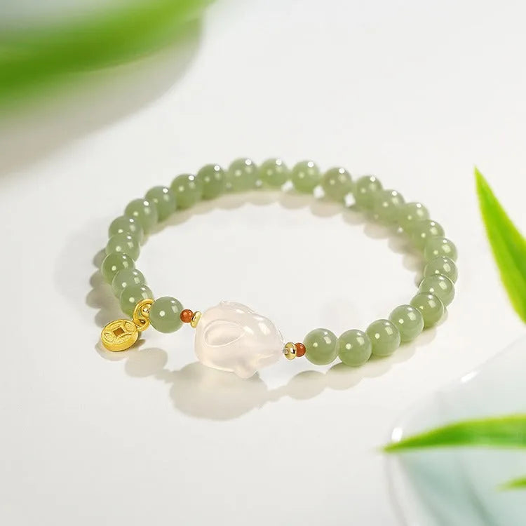 Handmade women's Hetian Jade Rabbit bracelet with glass rabbit charms in a gift box.