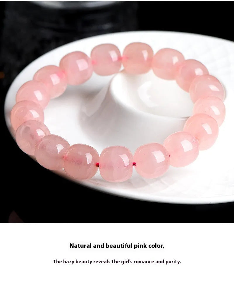 Natural pink crystal barrel bead bracelet with geometric design and polished finish
