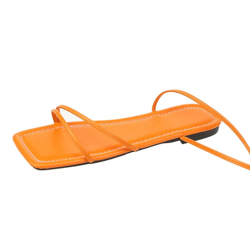 Women's flat sandals with ankle ring bandage cloth detail, square toe, and front lace-up straps in black.
