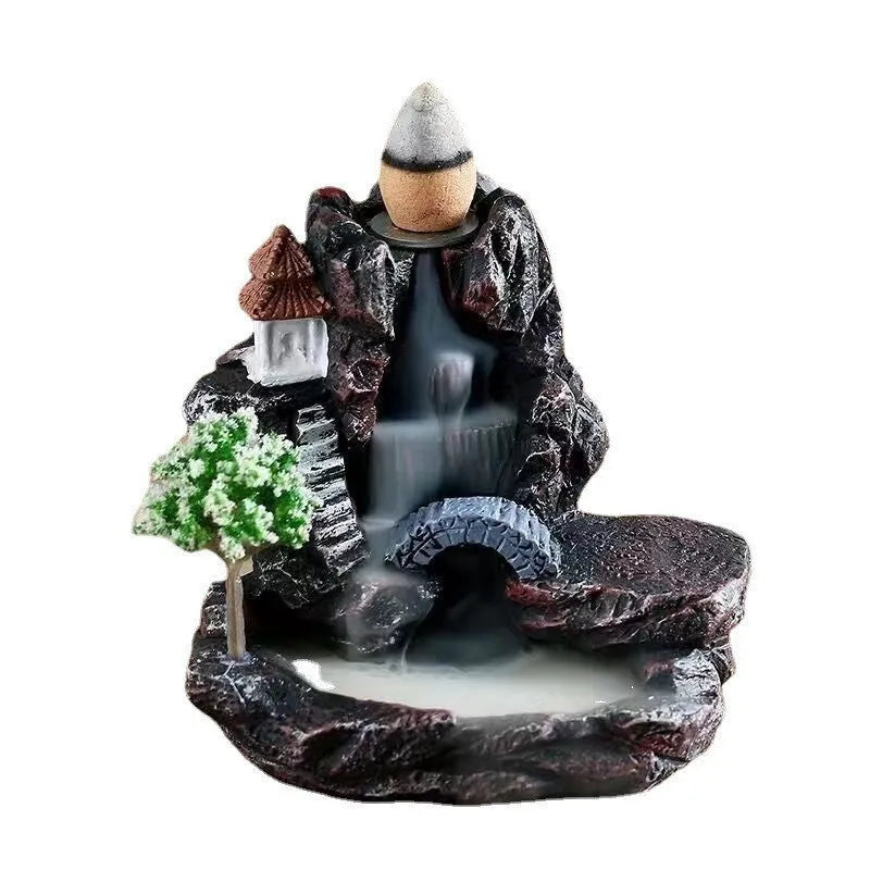 Ceramic backflow incense burner ornament in modern tree design on a table.