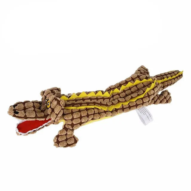 Blue crocodile-shaped plush squeaky dog toy with corduroy fabric on a wooden floor.
