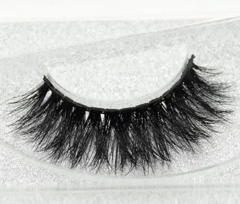 Pair of faux mink eyelashes with long tail and cotton stem against white background