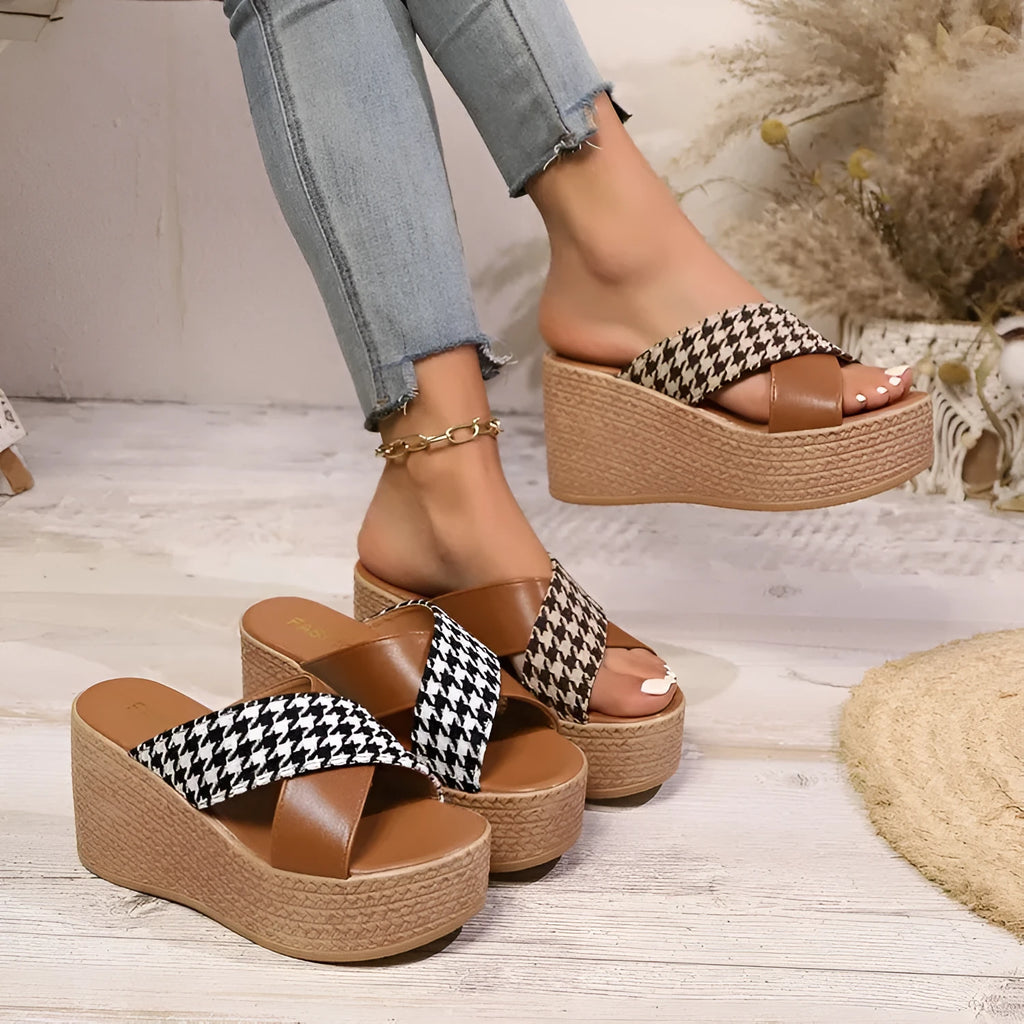 Casual brown and black plaid wedge sandals with cross-leopard pattern and rubber sole.