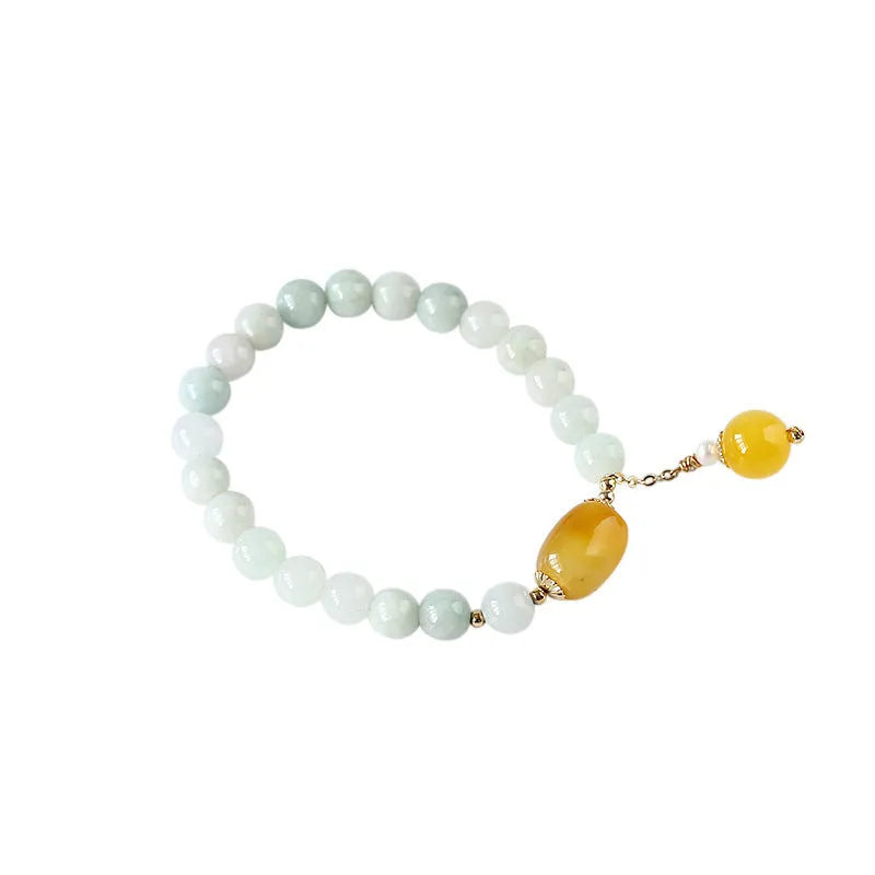 Women's ethnic style geometric bracelet with hanging agate tassel and 14K gilded details.