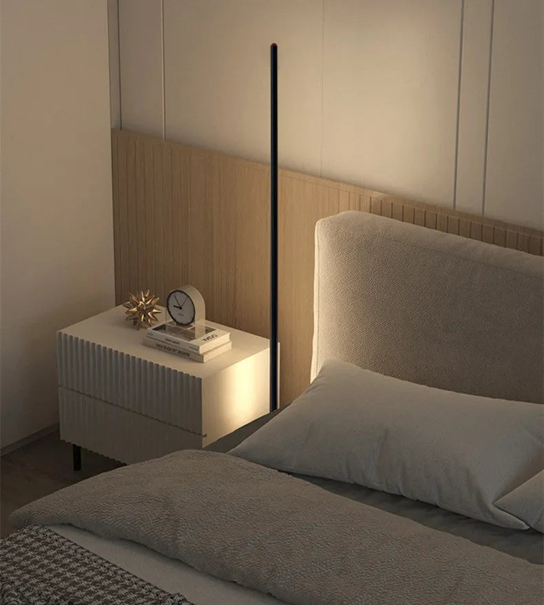 Vertical aluminium alloy floor lamp in modern simple style beside sofa