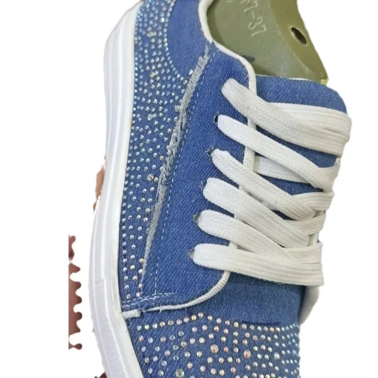Women's black casual sports shoes with lace-up front, rhinestone detail, and thick rubber sole.