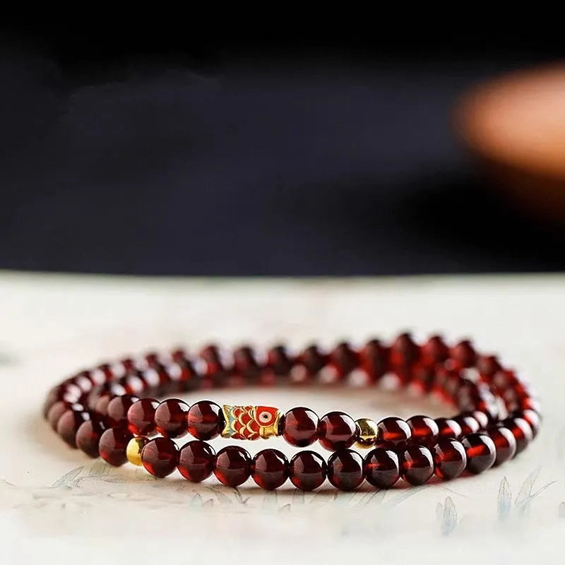 Close-up of a wine red glass bead bracelet showing micro beads and coloured glaze finish.