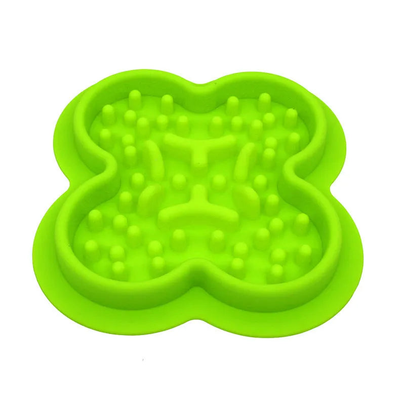 Silicone slow feeder licking pad for pets in various colours on a kitchen counter.