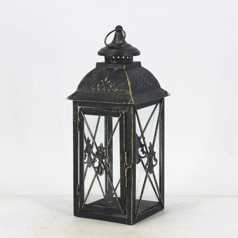 European wrought iron storm lantern with tempered glass in black or white gold finish, shown in small, medium, and large sizes.