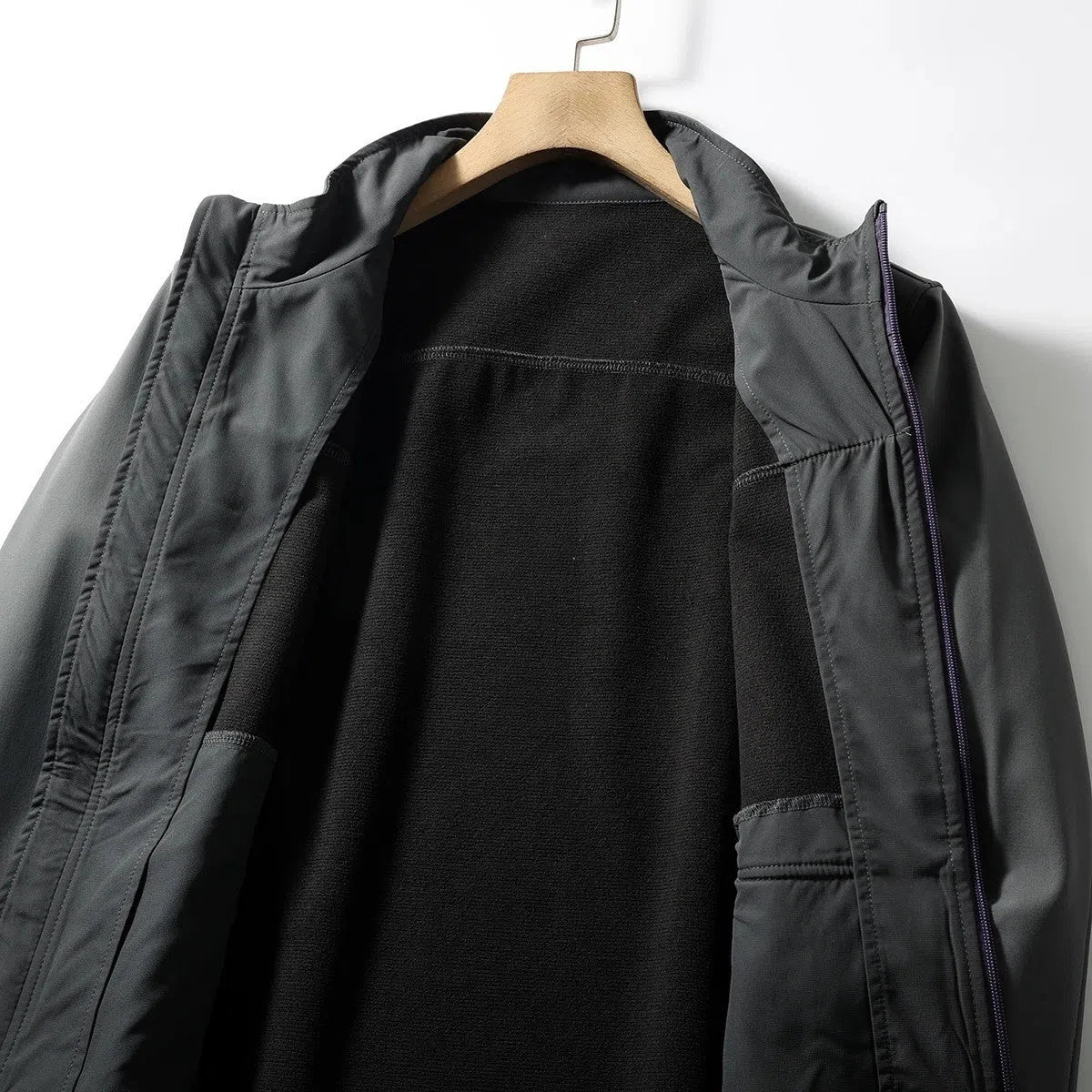 Men's retro patchwork contrast colour stand-up collar coat in Misty White, side view showing zipped pockets