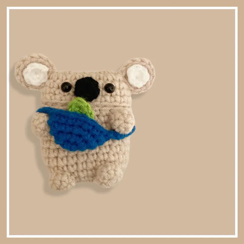 Hand knitted AirPods protective sleeve with koala bear backpack design on Apple AirPods case