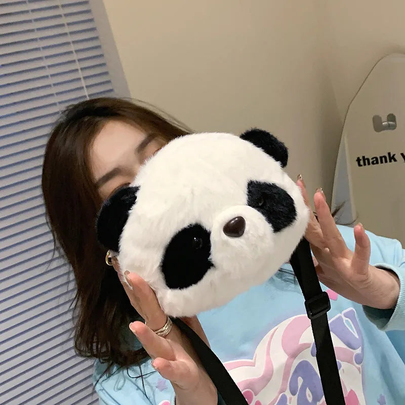 Soft plush cylindrical panda head crossbody bag with sandwich pocket.