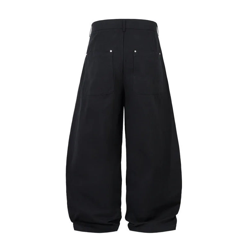 Black men's pleated casual trousers with a loose wide-leg fit on a hanger