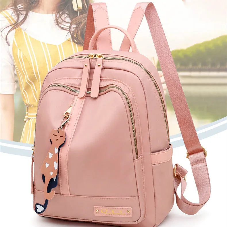Black nylon casual backpack with square vertical shape, soft handle, and three-dimensional outer pocket