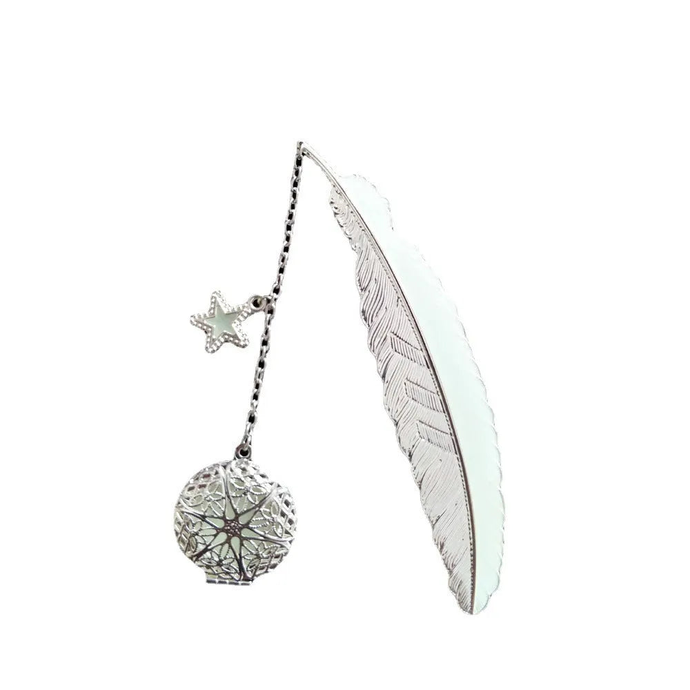 Silver pure copper feather bookmark with glowing luminous butterfly charm on a book.