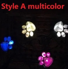 Four black paw print solar garden lights connected to central solar panel pole