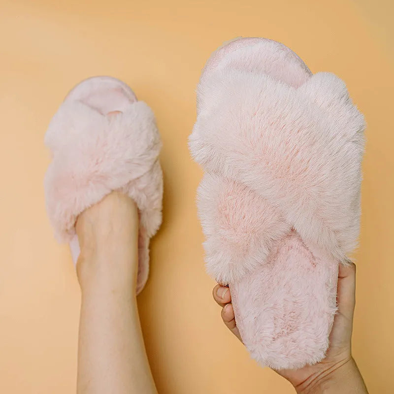 Women's beige faux fur cross-top slippers with suede upper and TPR sole on a wooden floor