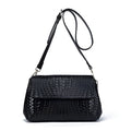 Genuine leather women's woven crossbody bag in black with embossed finish and soft handle