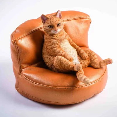 Small lazy cat model resting on a sofa, a resin car dashboard ornament decoration.