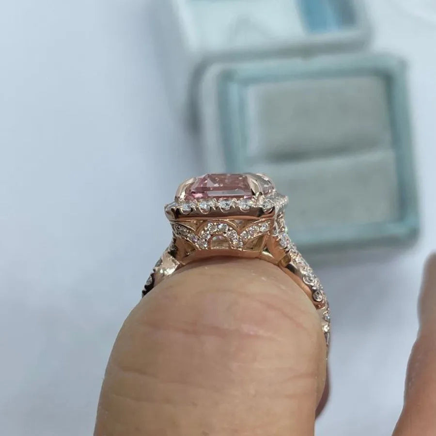 Rose gold geometric alloy ring on a plain background, showing its shape and electroplated finish.