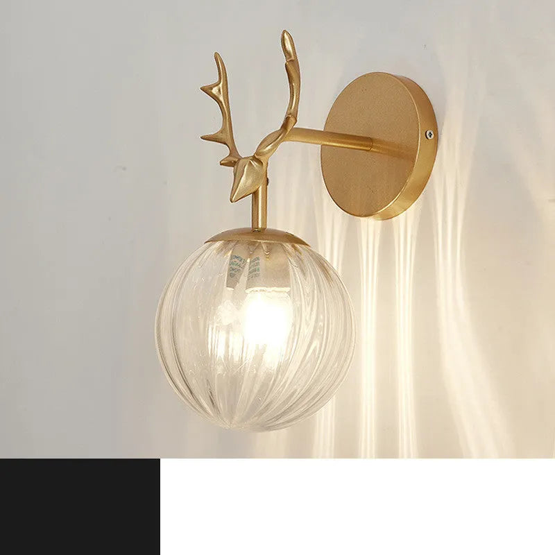 Round glass Nordic wall lamp with golden water pattern finish on a white wall.