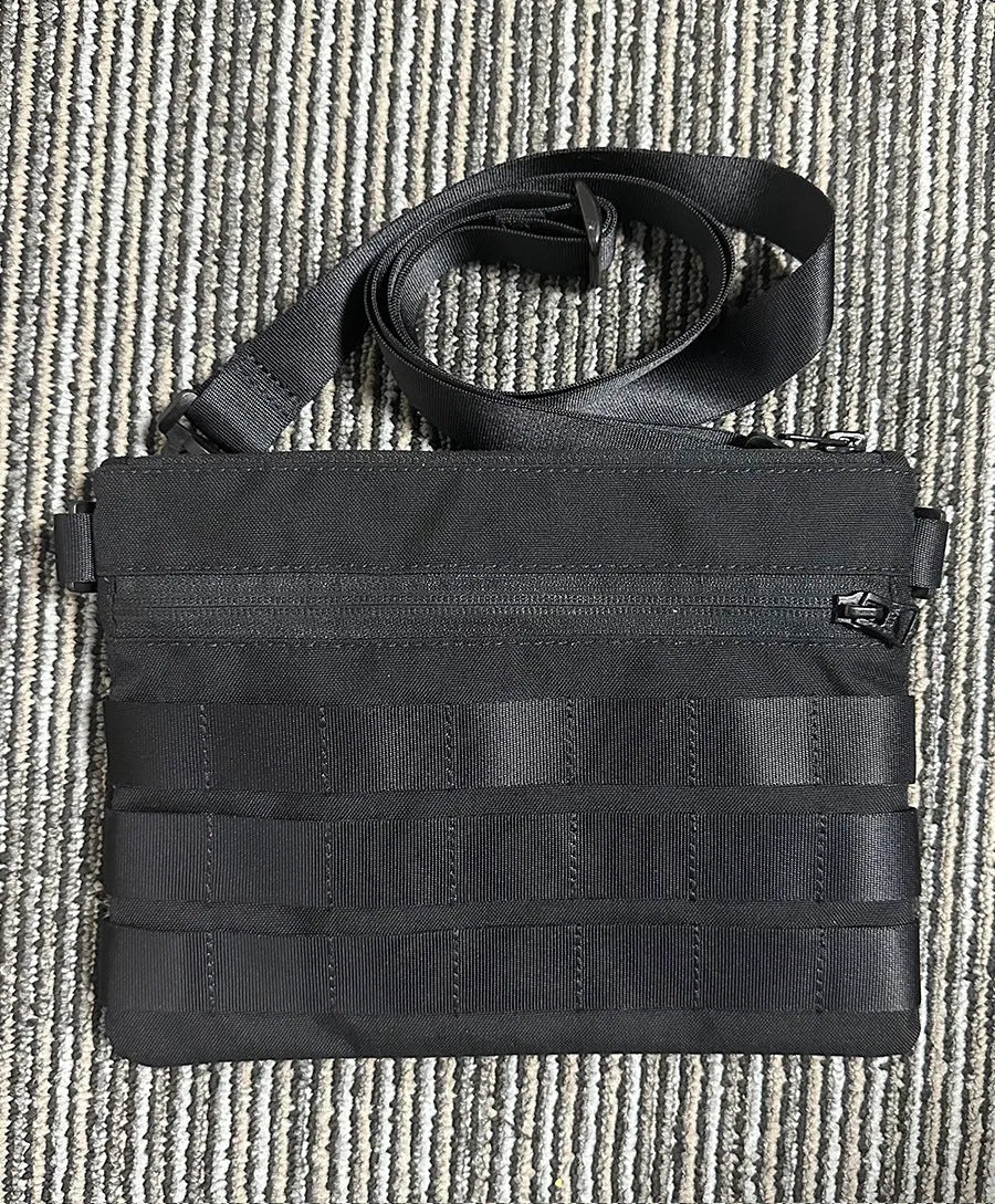 Black Oxford cloth portable outdoor organiser kit measuring 18 by 3.5 centimetres