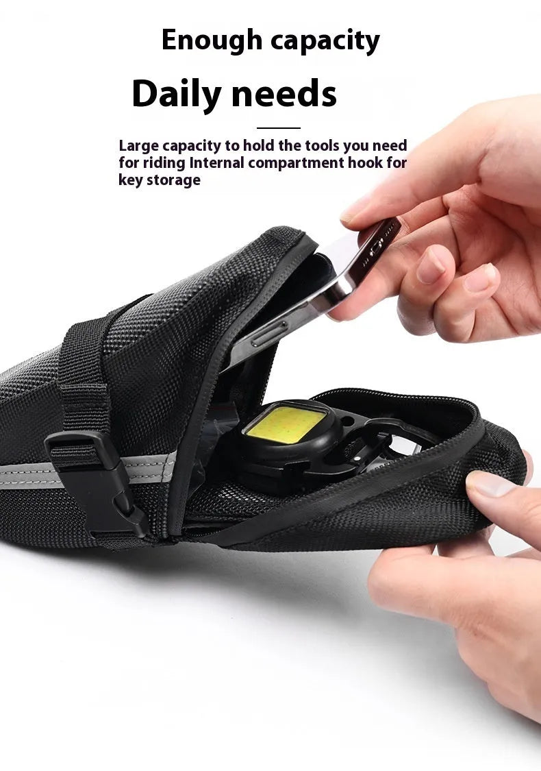 Black polyester bicycle saddle bag with quick release mount under a bike seat
