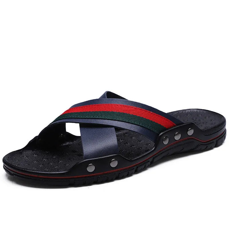 Men's blue cowhide leather flip-flops with a non-slip PU sole on a sandy beach.