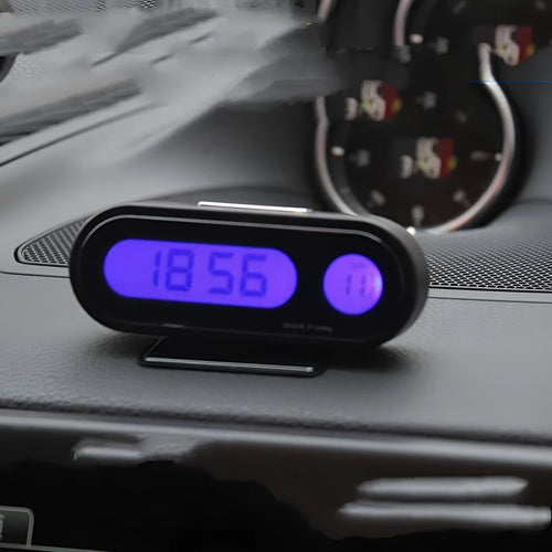 Black electronic car clock and thermometer with luminous digital display on an adjustable dashboard mount.