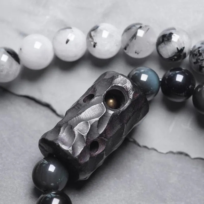 Ethnic black hair bracelet with white crystals and tassels showing bending lacing construction