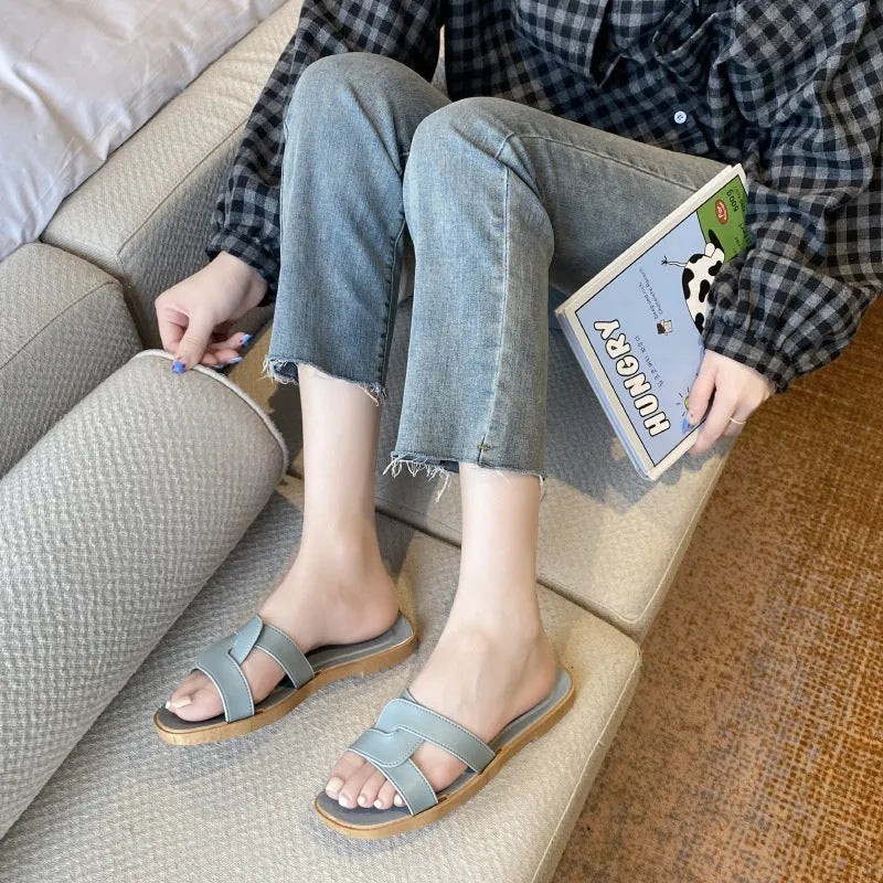 Women's PVC cross strap flip flop sandals in light blue on a white background.