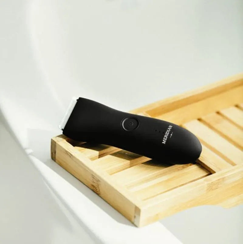 Waterproof cordless electric body hair trimmer in black with polycarbonate shell and two comb attachments