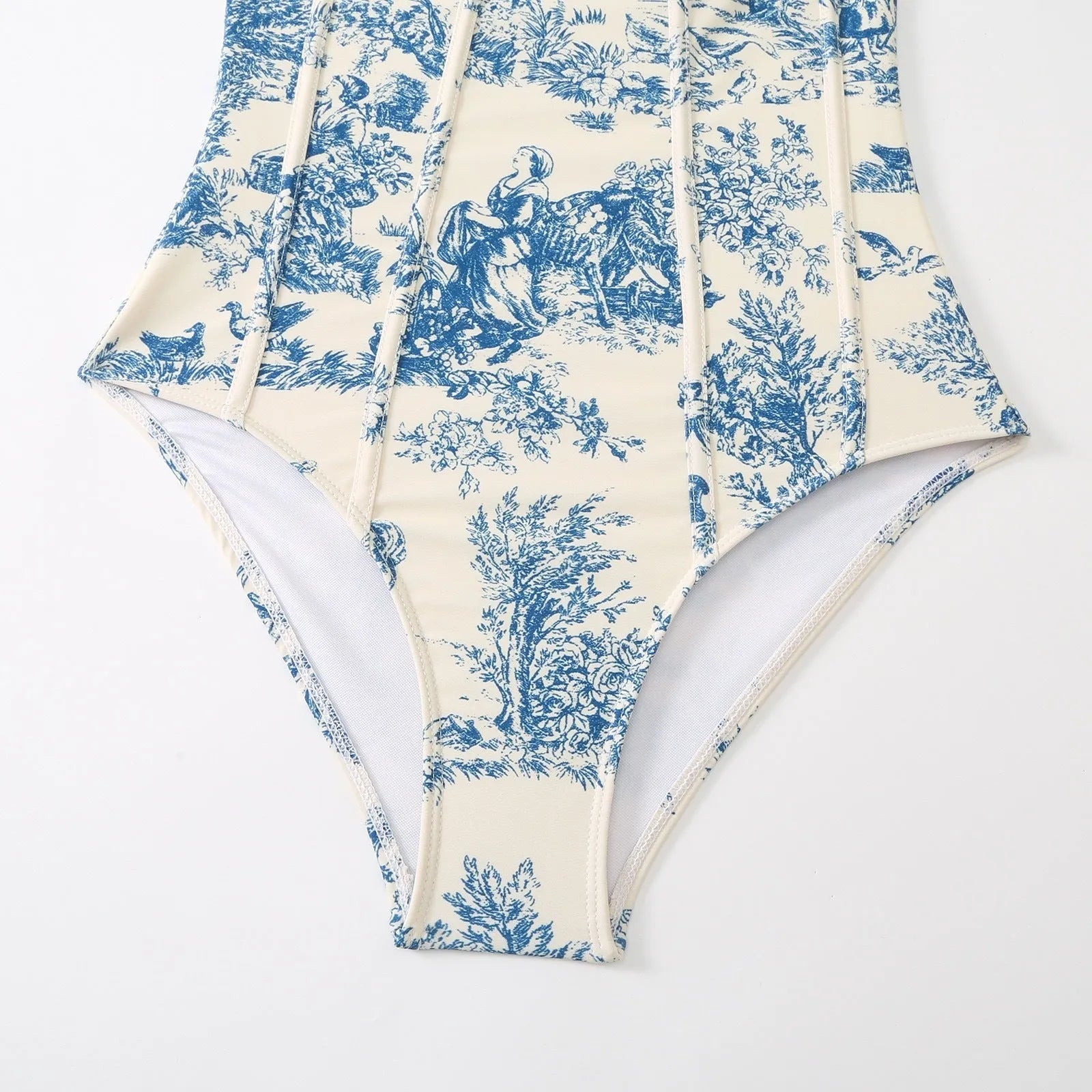 Blue women's one-piece swimsuit with matching gauze skirt on a model