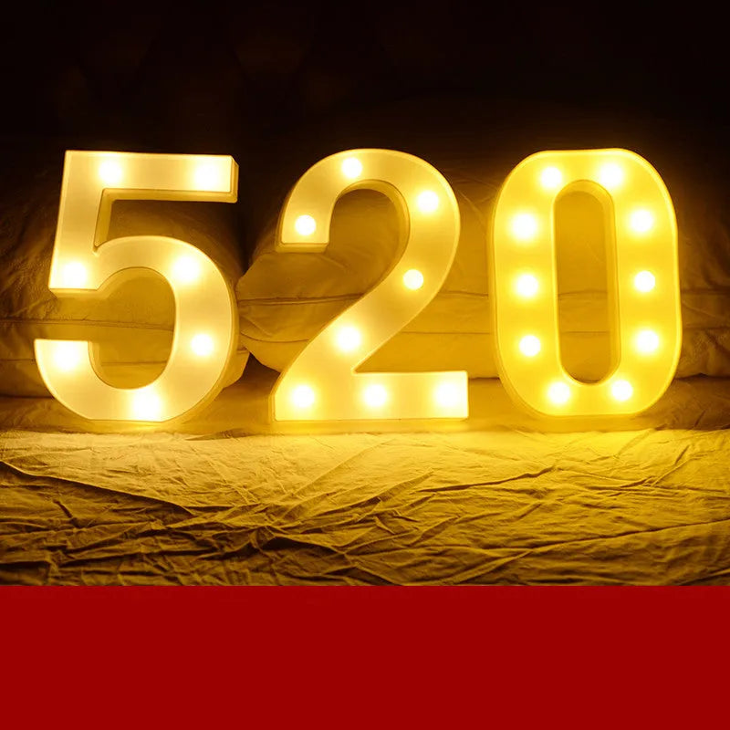Plastic LED letter light decoration spelling a message, 22cm in height.