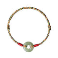 Handmade woven rope bracelet with silver peace buckle clasp on colourful braided cord