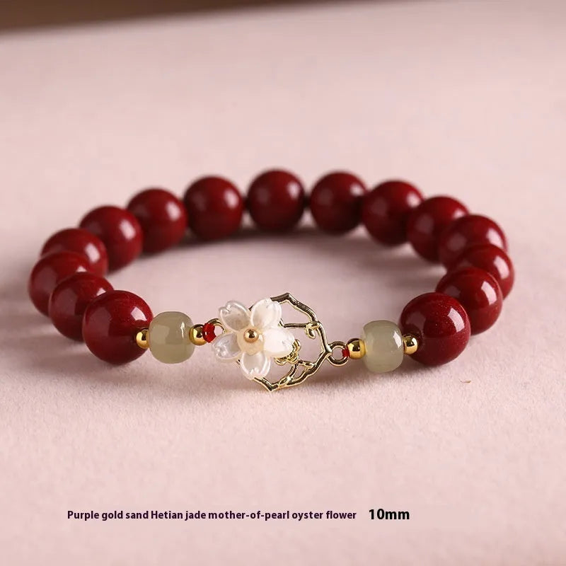 Cinnabar bracelet with Hetian Jade lotus charm and Bells of Ireland accents in New Chinese style