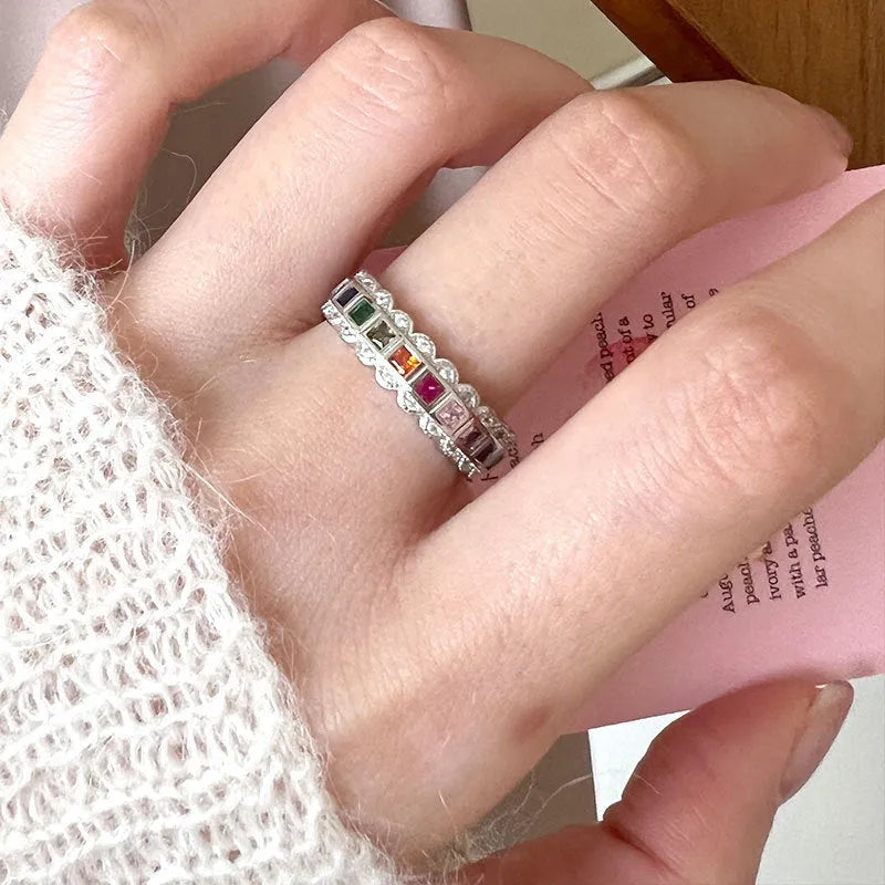 S925 sterling silver adjustable lace ring with rainbow zircon stones on a white background.