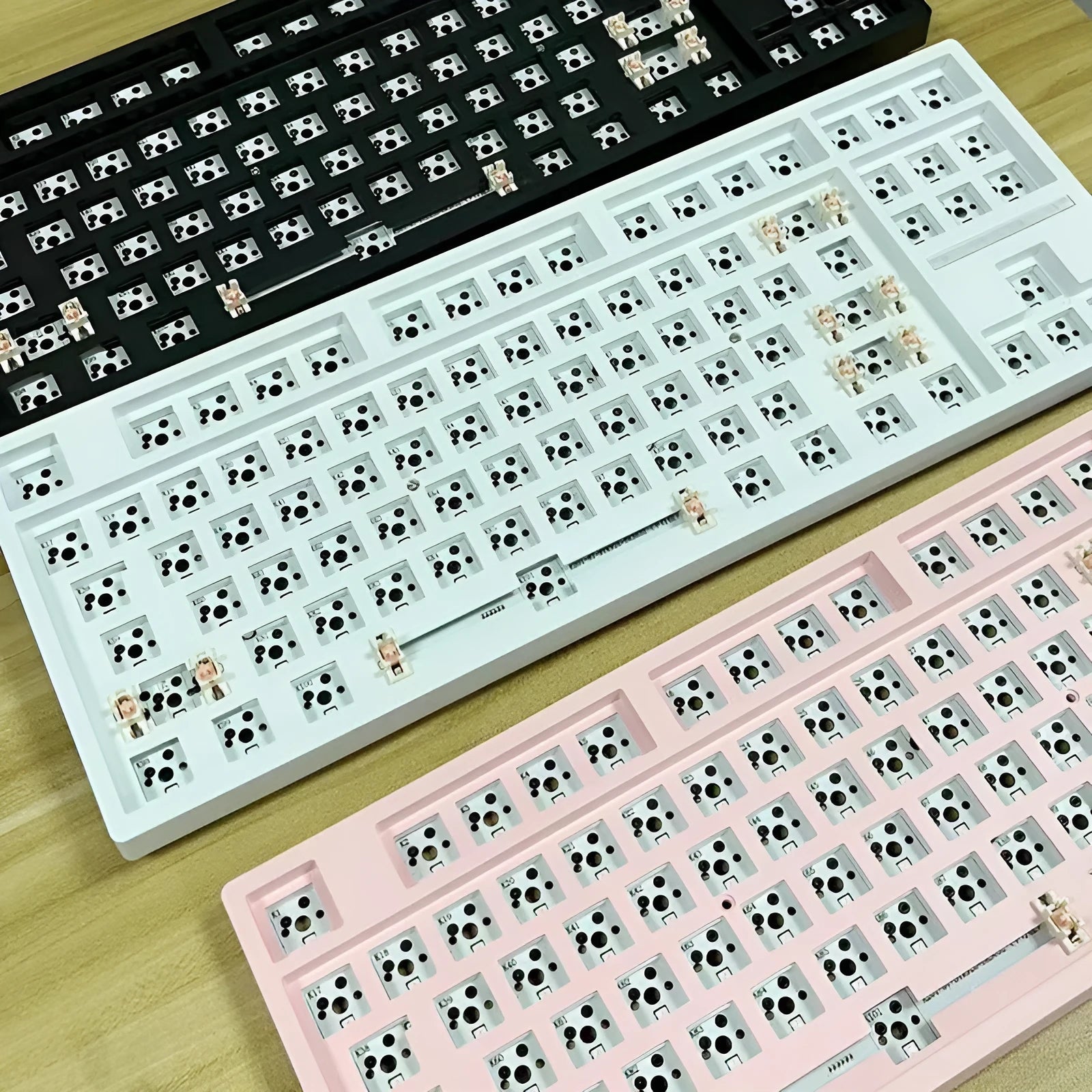 DIY mechanical keyboard kit with transparent case showing internal components and key puller tool