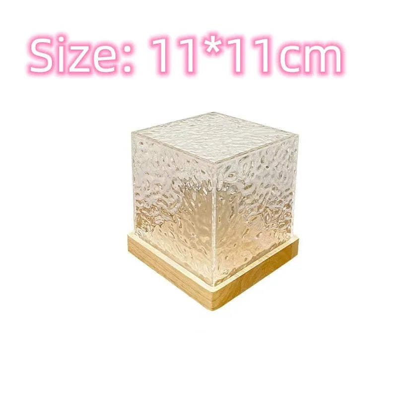 Geometric crystal LED table lamp projecting blue water ripple light patterns on wall with remote control