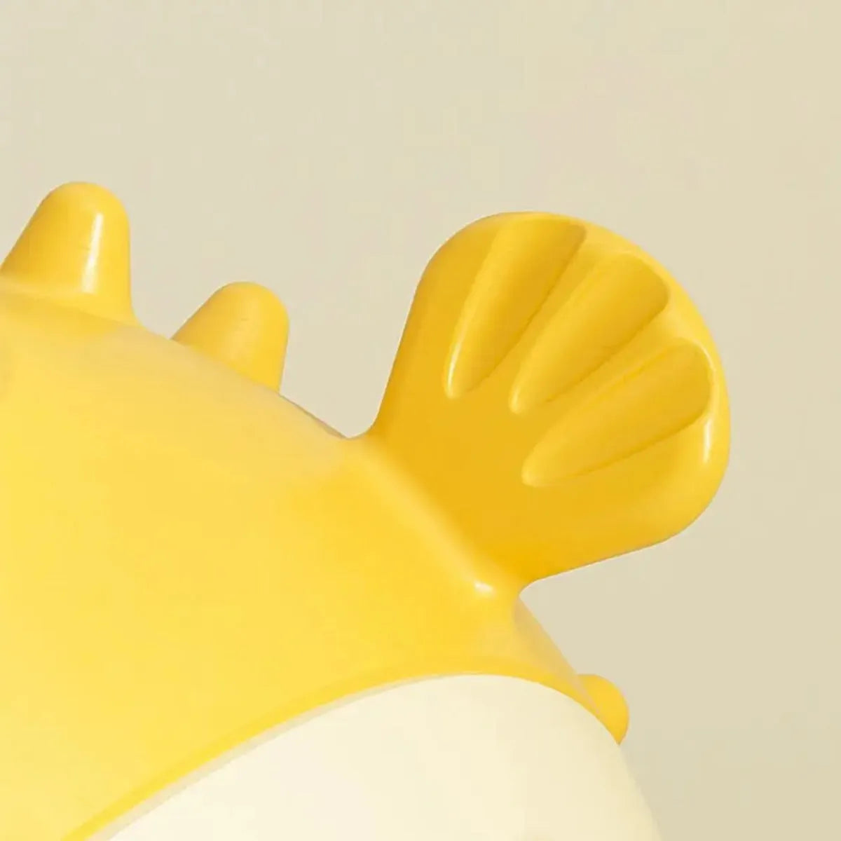 Yellow fish-shaped dog chew toy with textured surface and squeaker for aggressive chewers