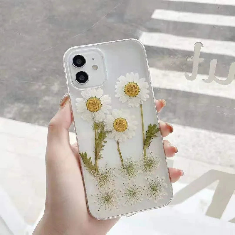 White iPhone case with epoxy daisy floral design on back cover, showing TPU protective construction