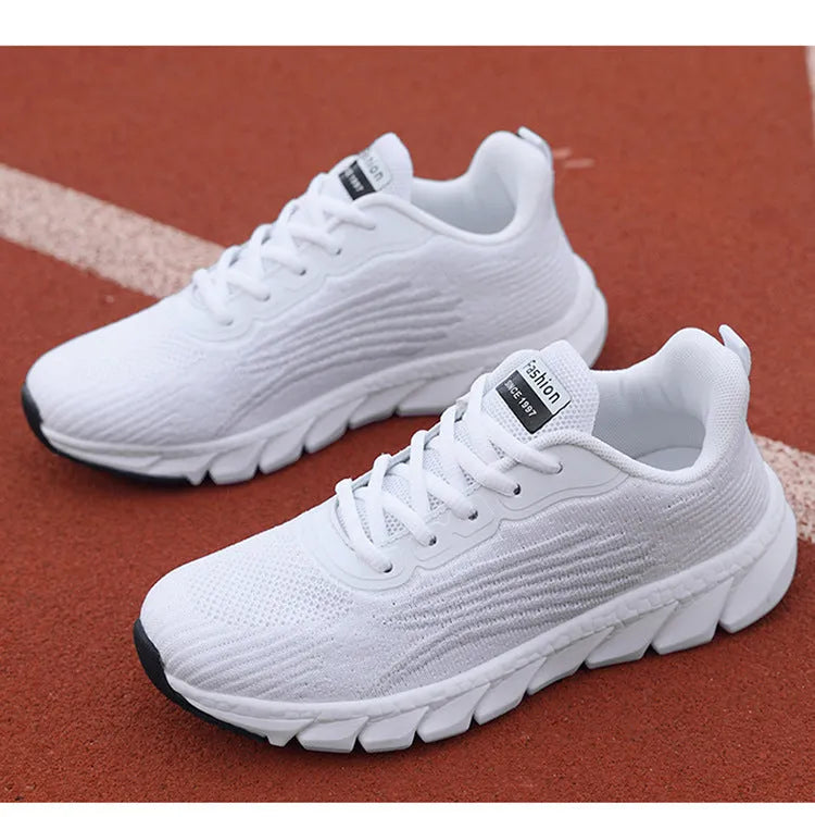 Women's low-top platform running sneakers in black and white colours with round toe and cross strap design