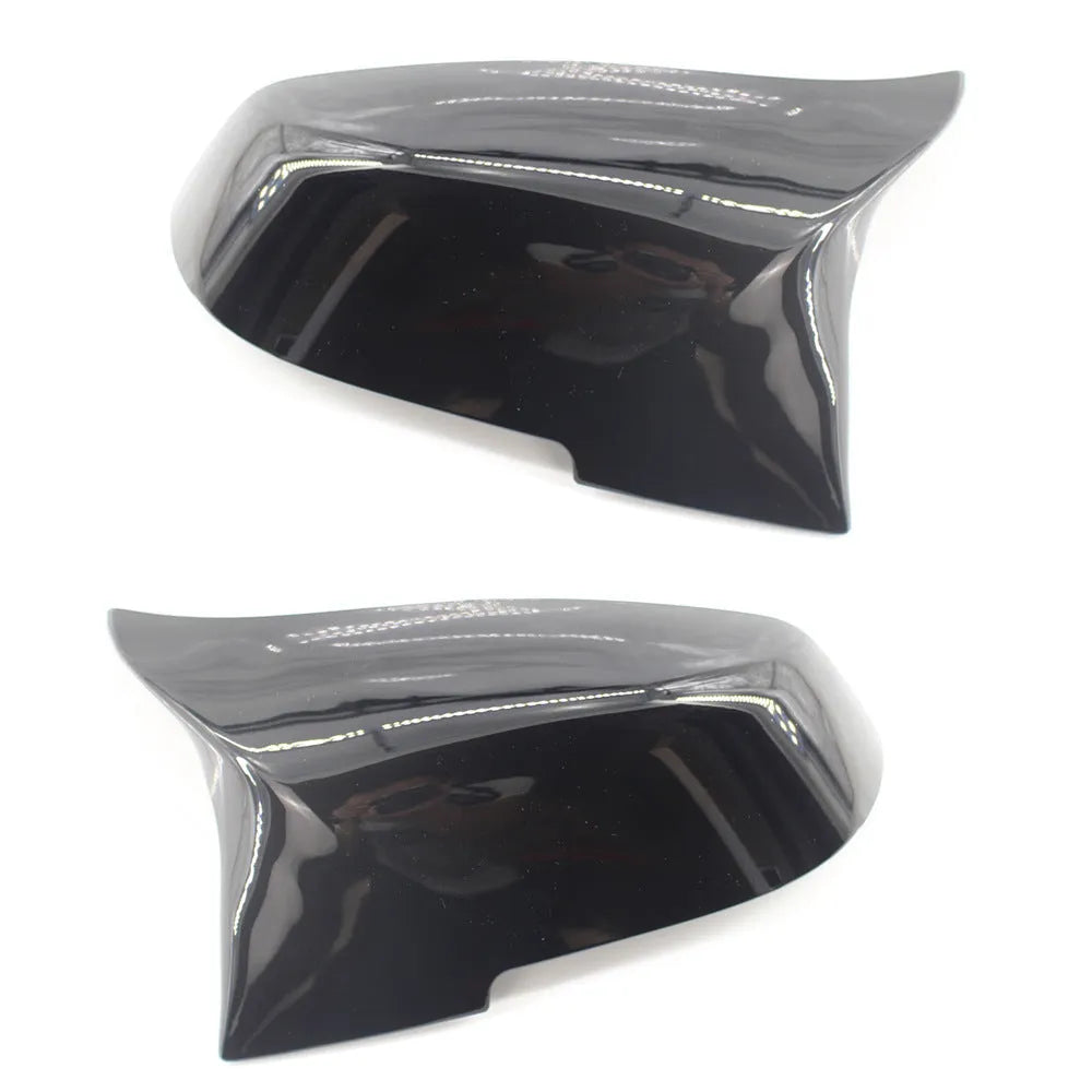 Pair of paint bright black BMW F-Series rear-view mirror replacement shells.