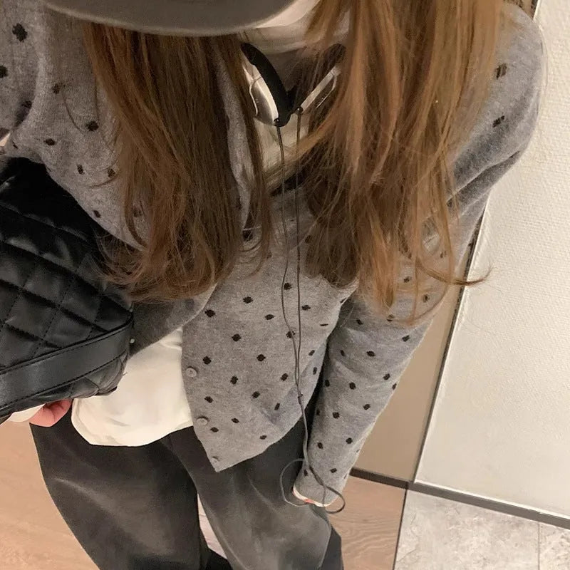 Women's grey Korean-style cardigan with crocheted flower detail on mannequin
