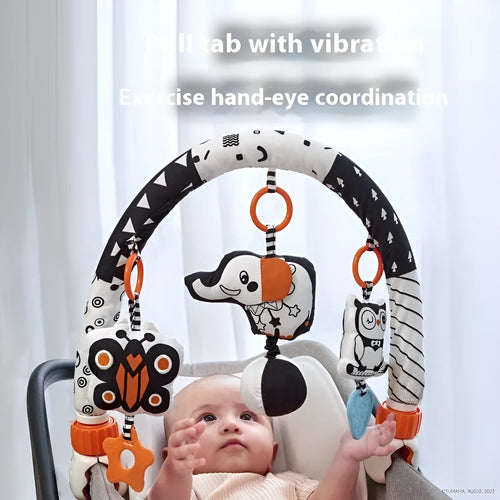 Baby lathe clip hanging plush toy in black and white with pull vibration teether, attached to a cot