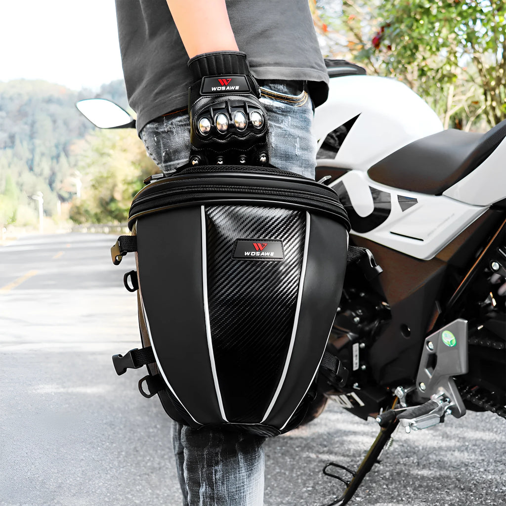 Black motorcycle seat bag with reflective strips, showing multiple pockets and an adjustable shoulder strap.