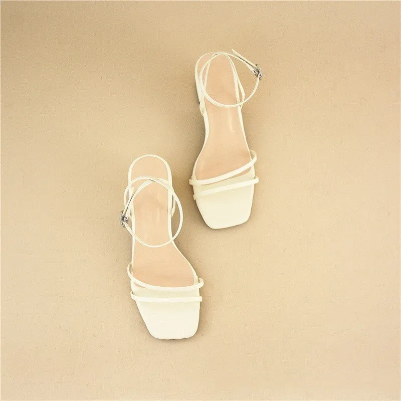Beige women's chunky heel sandals with a square toe and ankle strap on a rubber sole.