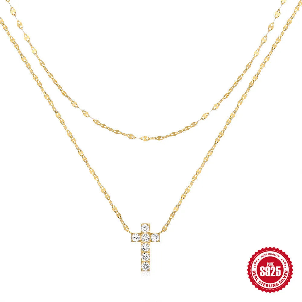 Sterling silver double layer cross pendant necklace with a clavicle chain in a gold tone finish.
