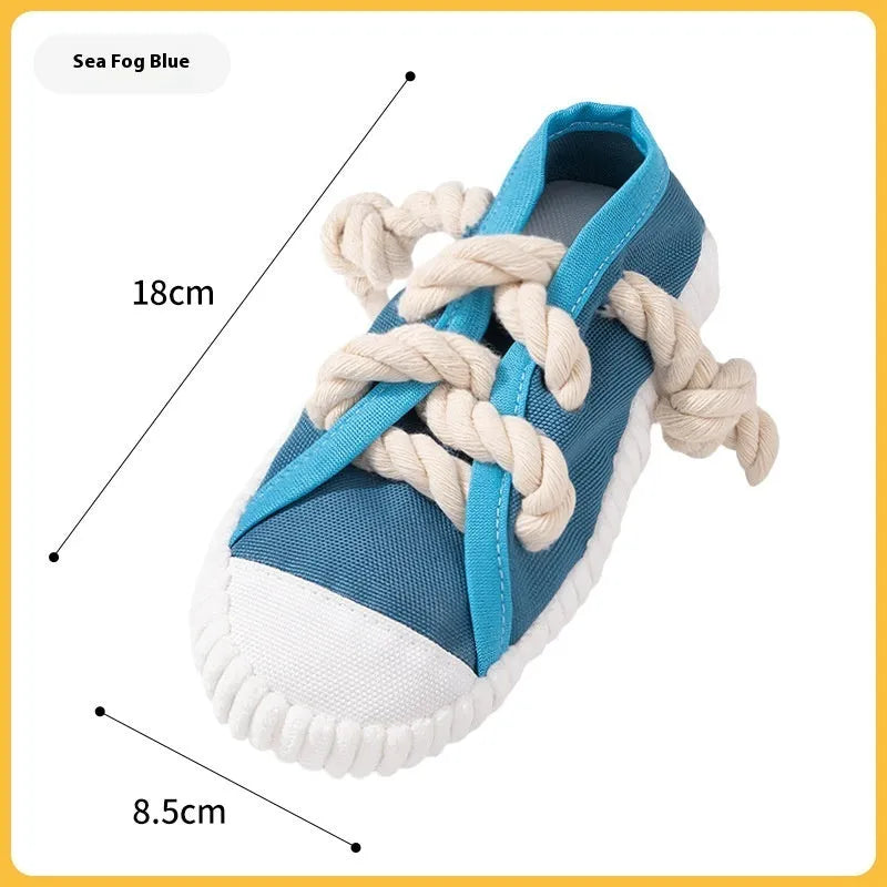 Plastic dog toy shaped like slippers in yellow, black, or blue, designed for chewing and making sound.