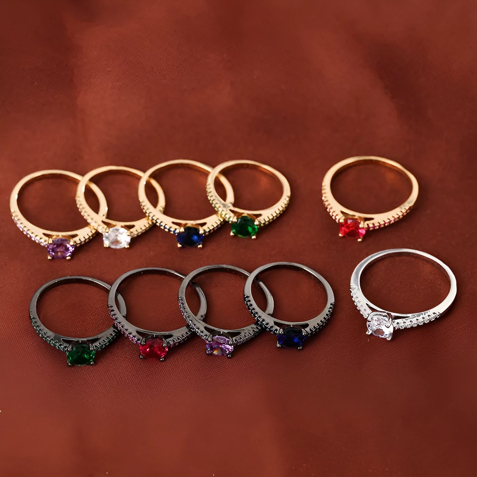Geometric hexagon zircon ring in copper on a grey background, showing gold rose red and gun black purple colour options.